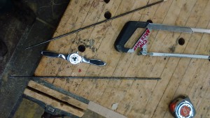 1/4" steel rod, with the threading die and tool. I used the nice vises in the architecture wood shop to secure the work.